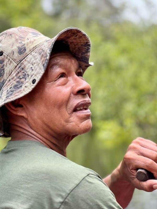 Portrait of a local Amazon guide in a camouflage bucket hat looking into the distance