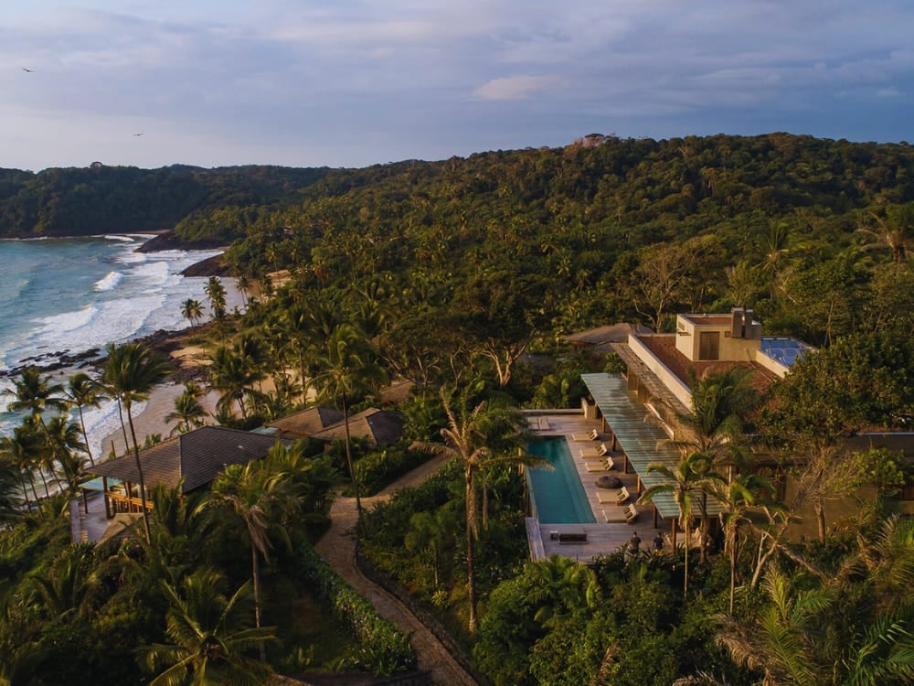 Aerial view of Barracuda Boutique hotel featuring a long pool overlooking the Atlantic ocean.