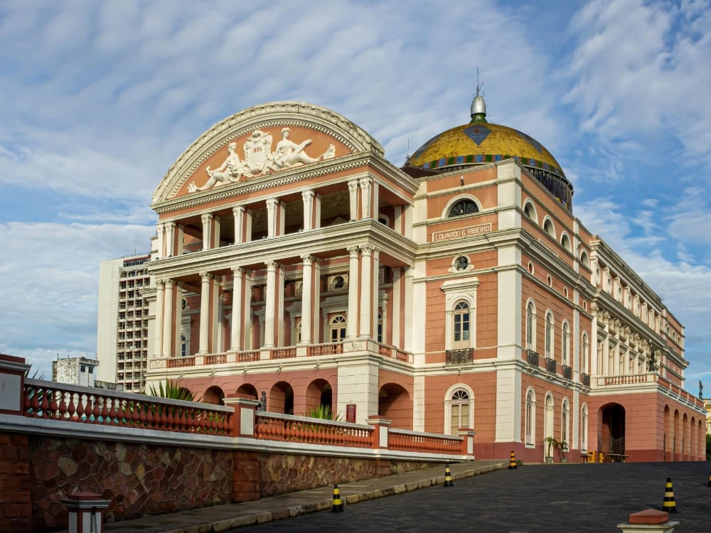 The Teatro Amazonas opera house featuring a colorful dome and pink facade in the Centro Histórico of Manaus.