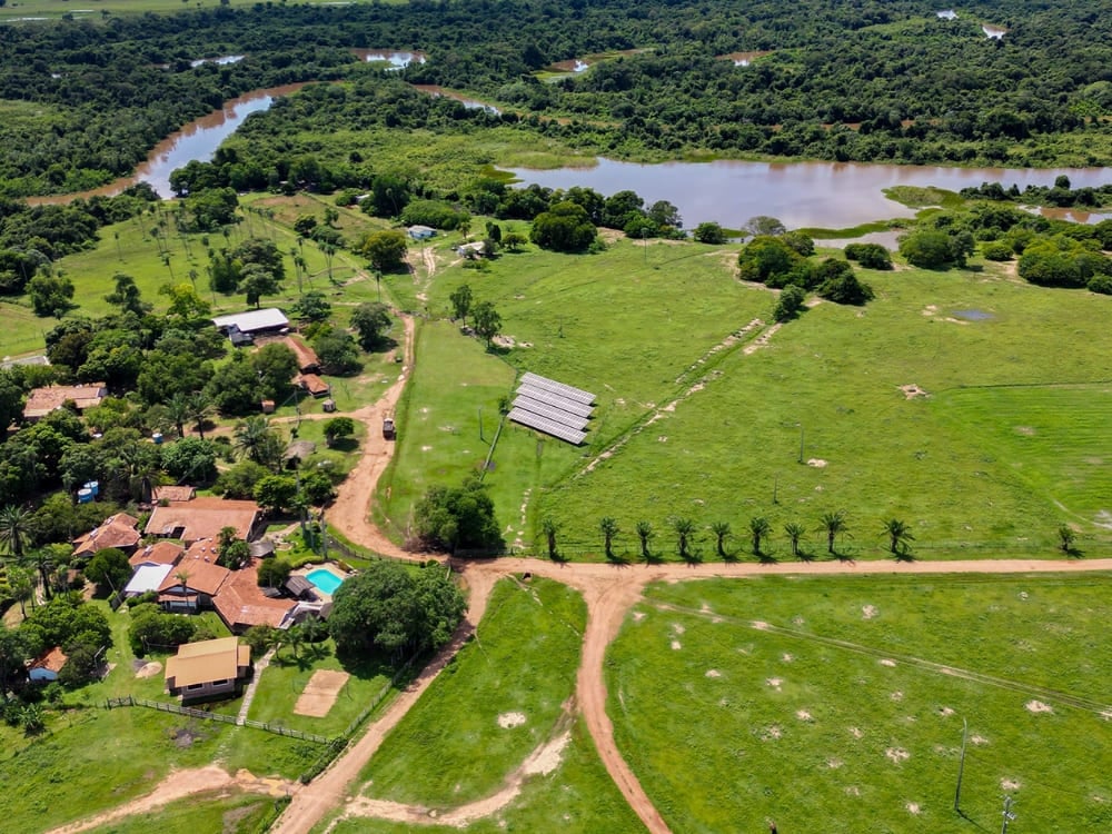 Aerial view of Aguapé lodge reveals a rich green area blending Cerrado vegetation with the Aquidauana River. Aerial view of Araras Lodge showing the swimming pool and eco-friendly infrastructure surrounded by the Pantanal ecosystem