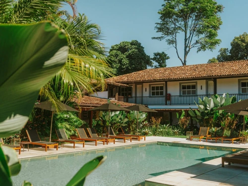 Calm water pool surrounded by lounge chairs and plants in the inner courtyard of a colonial inn. Calm water pool surrounded by lounge chairs and plants in the inner courtyard of a colonial inn.