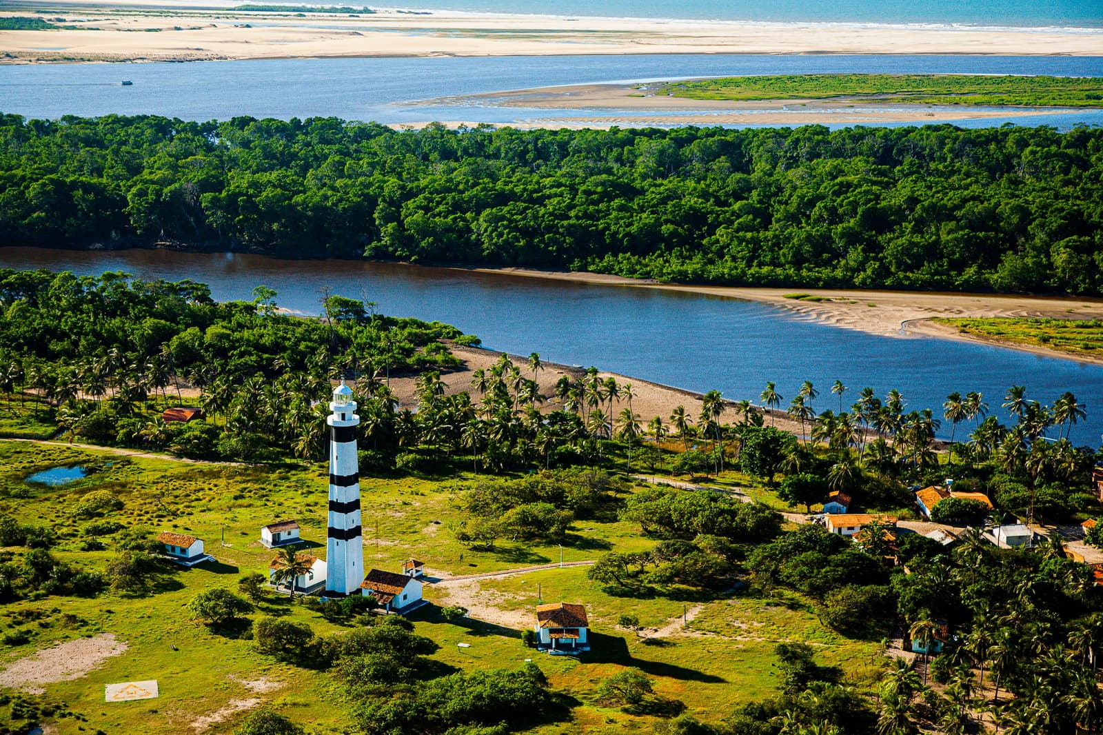 A lighthouse at the edge of everywhere, keeping watch over dunes, river, and forest at once. Photo: Gabriel Boieras Photo 1