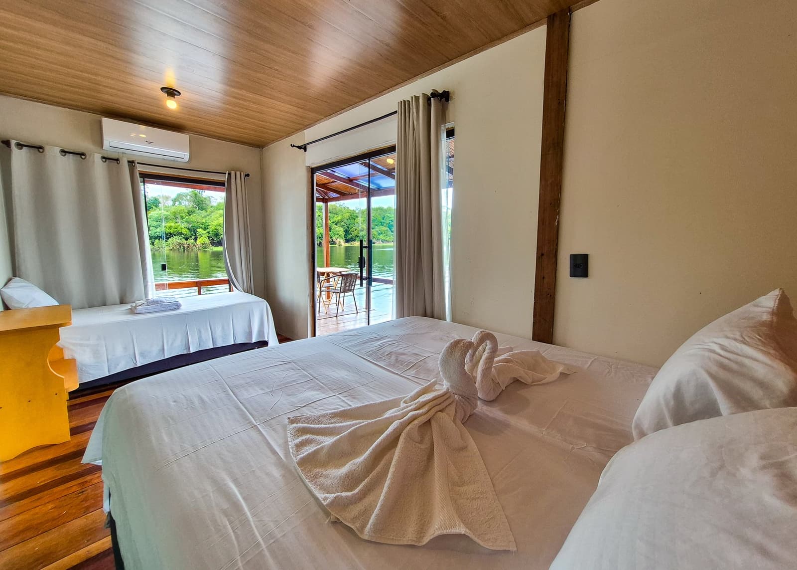 Towel swans, crisp beds, and a rainforest river framed in your doorway. Photo 2