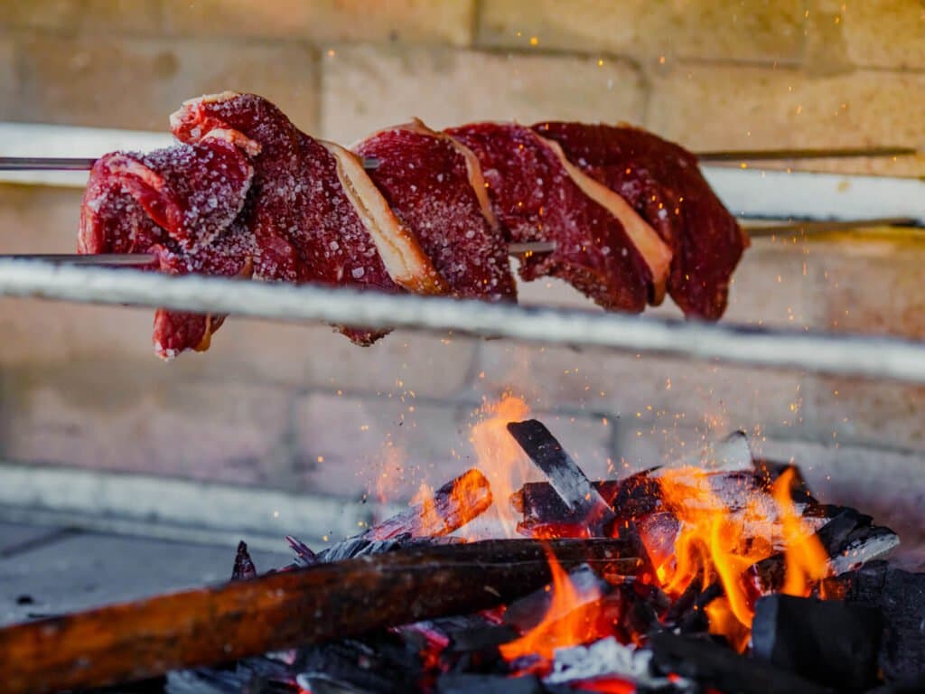 Salt, fire, and ember-kissed beef — dinner earned after a day on the river. Photo 2